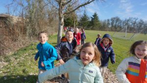 Children running through the grounds of Ashbrook Independent School toward the camera