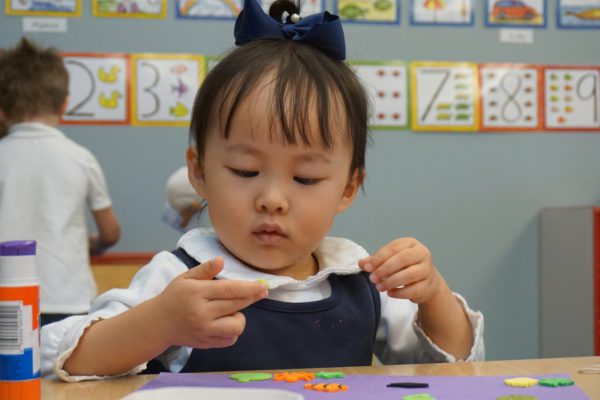 A young girl explores shapes in class at Ashbrook Independent School